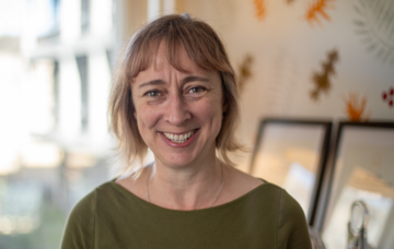 Head and shoulder shot of Catherine Goodwin wearing a dark green top 